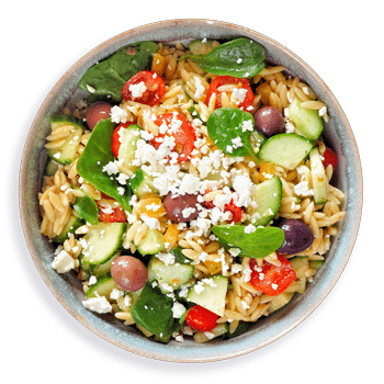 Bowl with orzo, cucumber, olives, feta cheese and spinach showcasing a Mediterranean-influenced healthy diet a nutritionist might recommend