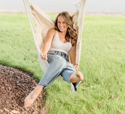 Kylie Fagnano, dietitian nutritionist in Washington DC, swings in a hammock chair